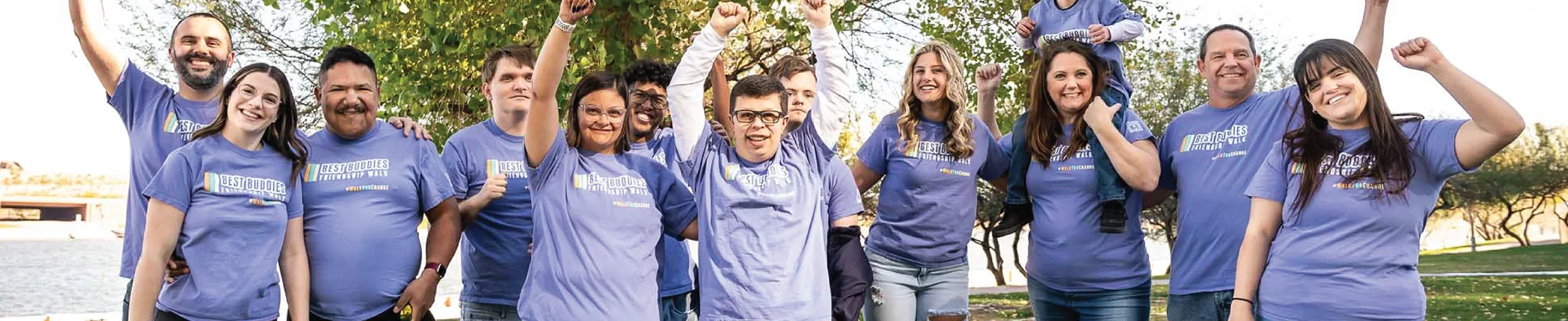 Large group of friendship walk participants smiling at event